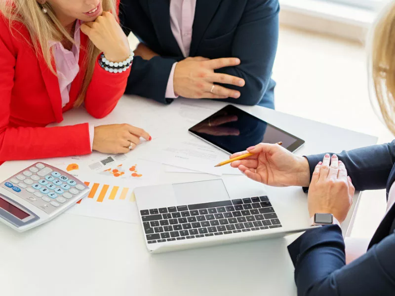 advisors showing clients something on laptop